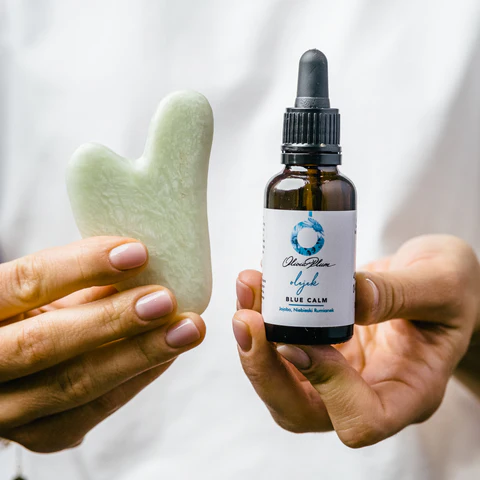 Gua sha stone with facial oil
